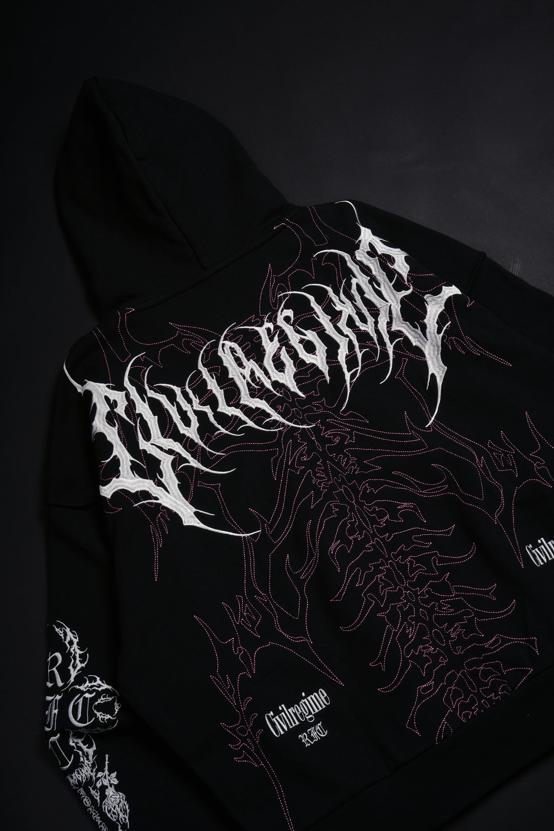 Surging Through The Blossoms Outliers Distressed Zip Up Hoodie in Black/Pink